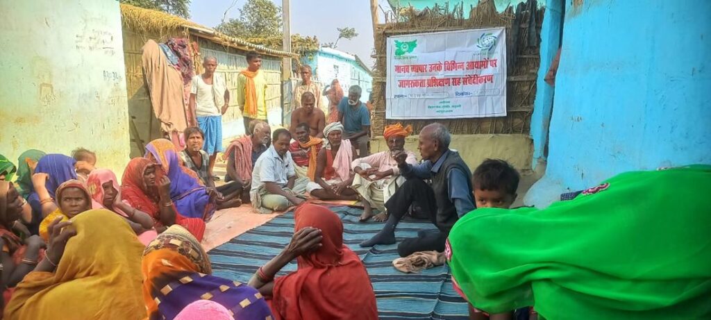 Villagers at an outdoor meeting