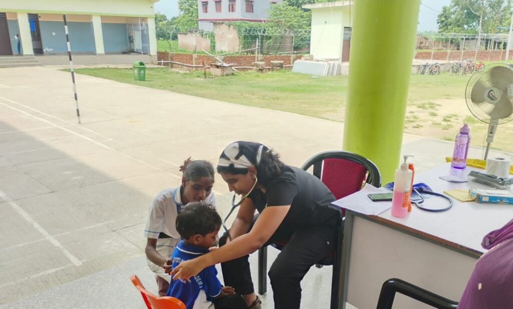 A doctor examining a child at a BSS medical camp