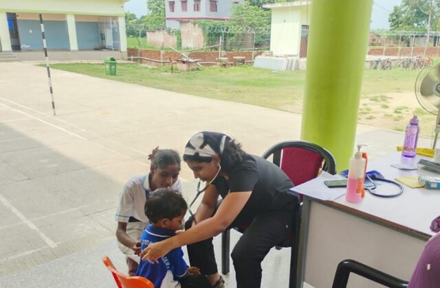 A doctor examining a child at a BSS medical camp