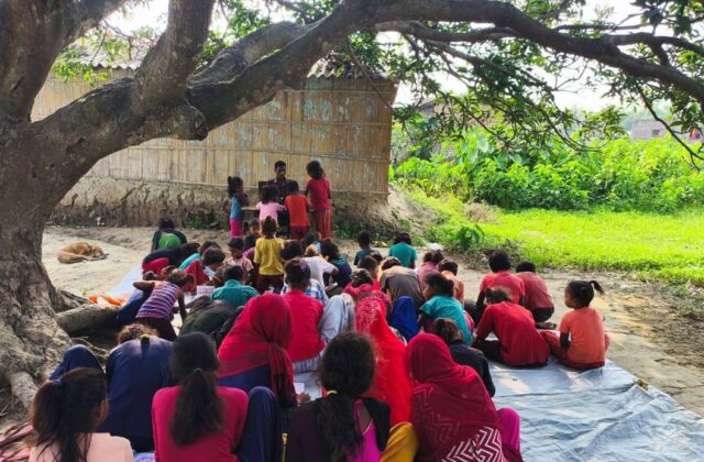 Children studying under a tree at the non-formal education centre